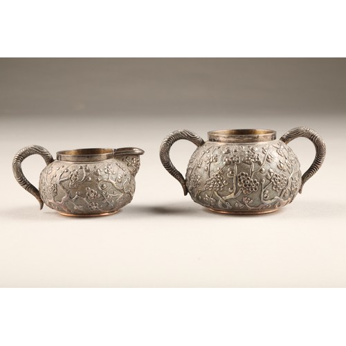 198 - Three piece Chinese silver tea service comprising of teapot, sugar bowl & cream jug with embosse... 