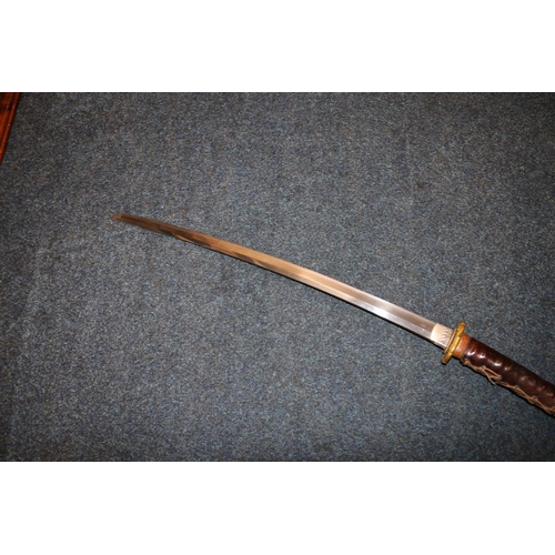 609 - Japanese katana sword with shagreen grip and bronze tsuba, blade length 60cm, sword length 87cm, wit... 