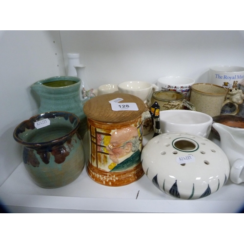128 - Collection of decorative items including a large glass vase, art pottery jugs, tankards, commemorati... 