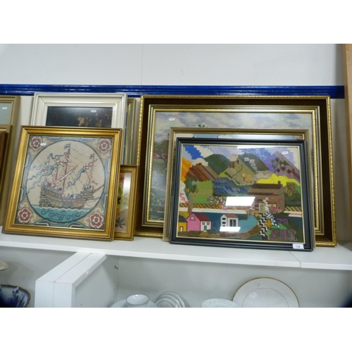 138 - Seven framed tapestries depicting cottages, boats etc.