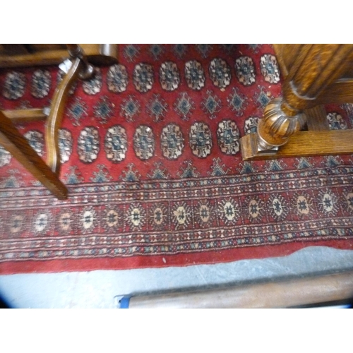 414 - Pair of Bokhara-style red ground rugs.