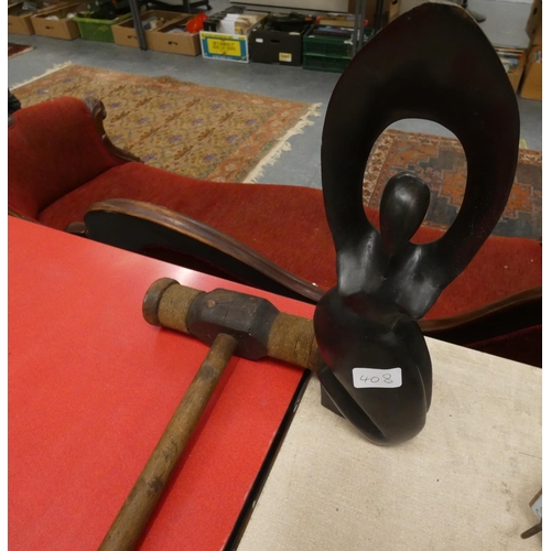 408 - Treen sculpture of a woman with arms aloft and a wooden mallet.