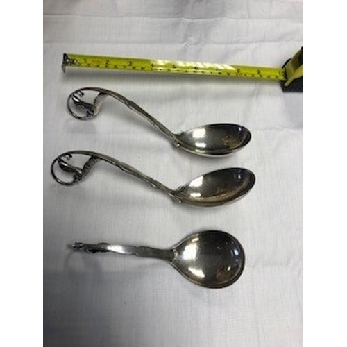 183 - Boxed set of three Georg Jensen Silver serving spoons, with scrolled handles with leaf finials, hamm... 