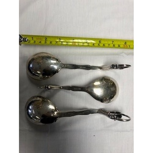 183 - Boxed set of three Georg Jensen Silver serving spoons, with scrolled handles with leaf finials, hamm... 