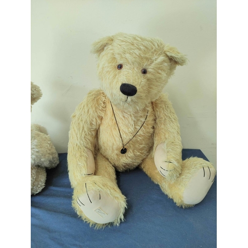 55 - Two large teddy bears to include a white mohair growler by Thread Bears England, Height 43cm and an ... 