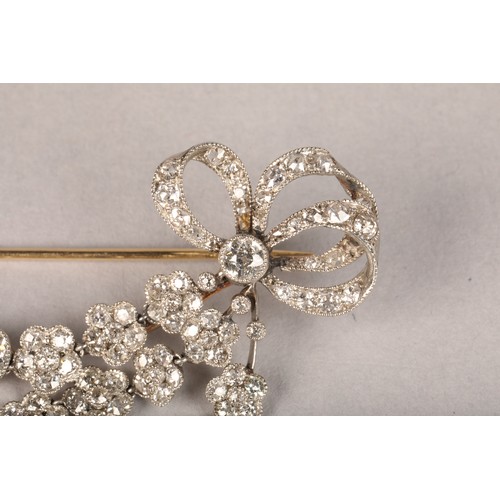 58 - Diamond bar brooch, diamond set bows to either end with three suspended rows of diamond florets. Top... 