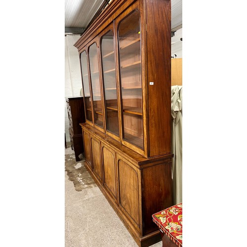 584 - 19th century mahogany bookcase, four glazed doors over four cupboard doors, shelved interior, length... 