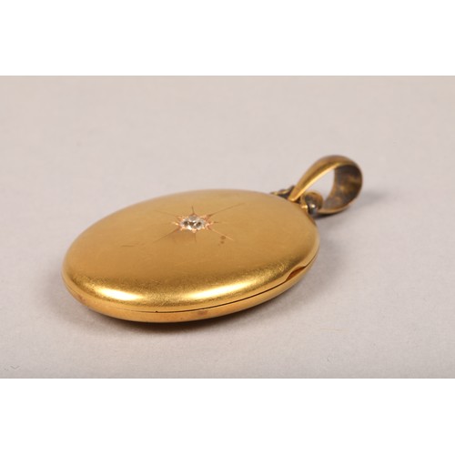 69 - Victorian yellow metal oval locket pendant set with 
a 0.33 carat diamond