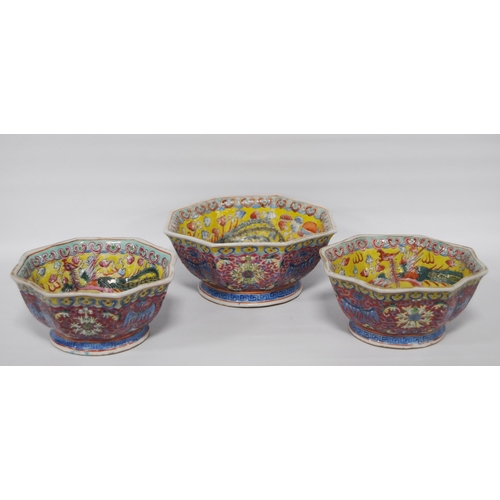 265 - Three Chinese porcelain Qianlong (1711 - 1799) famille rose octagonal bowls, red seal mark to the tu... 