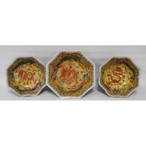 265 - Three Chinese porcelain Qianlong (1711 - 1799) famille rose octagonal bowls, red seal mark to the tu... 