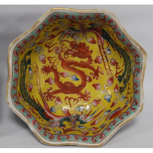 265 - Three Chinese porcelain Qianlong (1711 - 1799) famille rose octagonal bowls, red seal mark to the tu... 