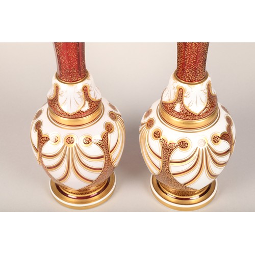 29 - Pair of Bohemian white overlay and gilt ruby vases, of flared baluster form, height 38cm