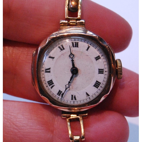 129 - Lady's 9ct gold watch on expanding part-gold bracelet.