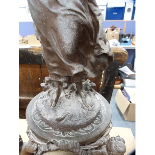 121 - Continental spelter clock surmounted by a figure.