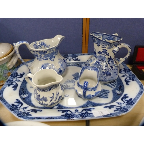 13 - Blue and white 'Willow' pattern ashet, Mason's blue and white jug and three others.