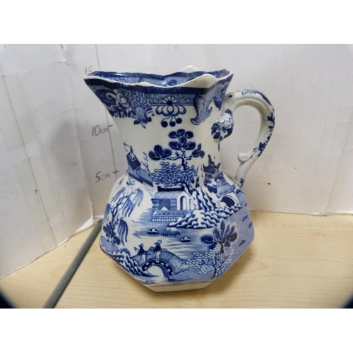 13 - Blue and white 'Willow' pattern ashet, Mason's blue and white jug and three others.