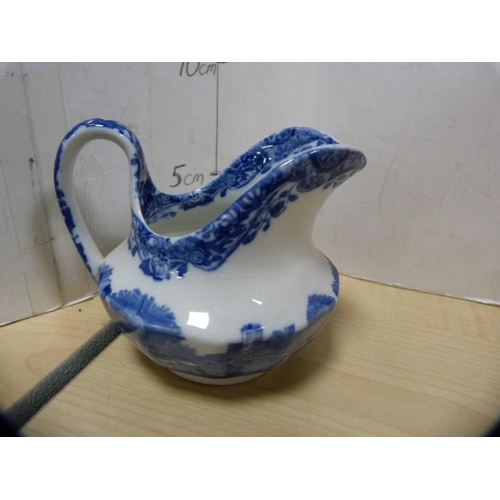 13 - Blue and white 'Willow' pattern ashet, Mason's blue and white jug and three others.