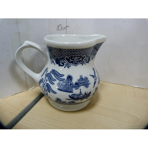 13 - Blue and white 'Willow' pattern ashet, Mason's blue and white jug and three others.