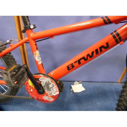 130 - Child's B-Twin mountain bike and helmet.