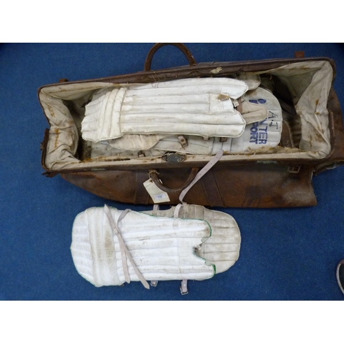 132 - Quantity of cricket pads, some marked for Harrods, contained in a large Gladstone-type bag.