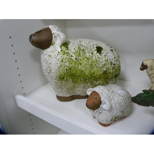 192 - Painted terracotta figures of sheep, painted doorstop modelled as a sheep and another (one shelf).  ... 