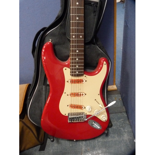 24 - Fender Squire Bullet Strat electric guitar on stand with Freshman Avalanche practice amplifier.