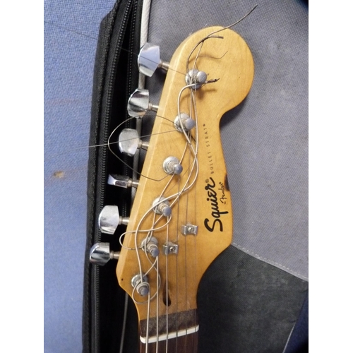 24 - Fender Squire Bullet Strat electric guitar on stand with Freshman Avalanche practice amplifier.