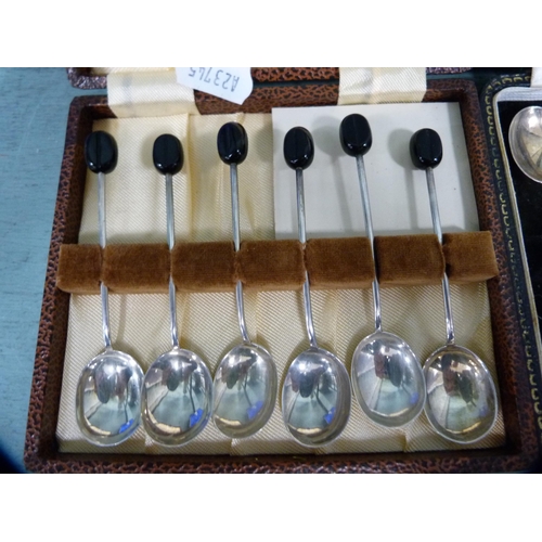 246 - Two sets of six silver coffee spoons with bean terminals, boxed.