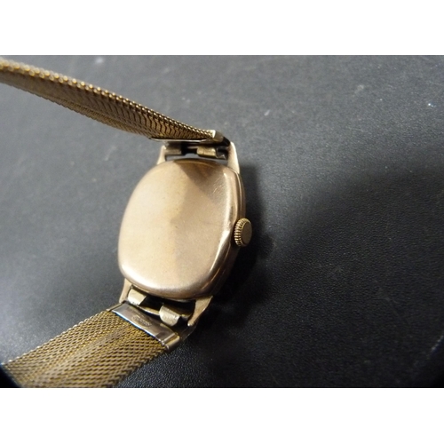 261 - 9ct gold-backed vintage gent's Invicta watch on a flexible bracelet, 34.2g gross.