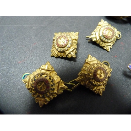 267 - Group of military cap badges, similar cloth badge and buttons.