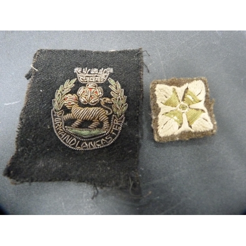 267 - Group of military cap badges, similar cloth badge and buttons.