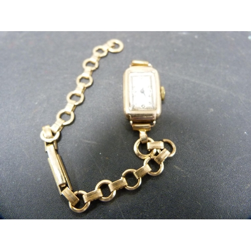 269 - Yellow metal chain, catch stamped '375', and a lady's yellow metal and rolled gold wristwatch.