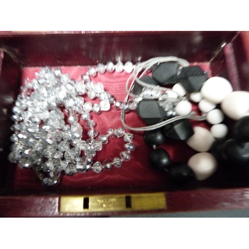 285 - Costume jewellery to include beads, brooches etc., contained in a jewellery box.