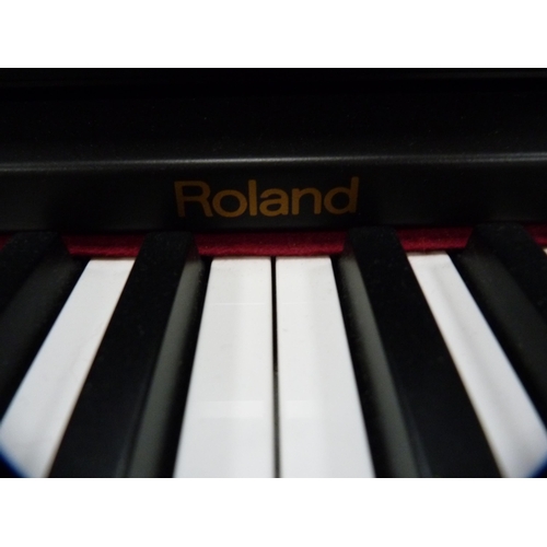 352 - Roland digital piano, HP1800E, with stool and a selection of sheet music.