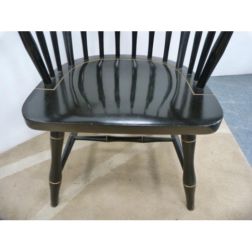 418 - Ebonised spindle-back elbow chair, crested.