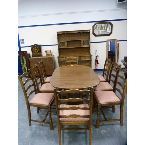 421 - Ercol ten-piece dining suite comprising a unit, table and eight chairs.