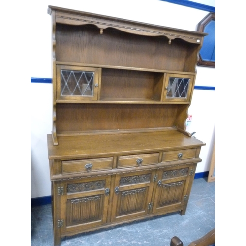 421 - Ercol ten-piece dining suite comprising a unit, table and eight chairs.