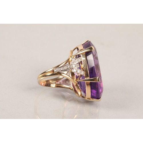 36 - Ladies large amethyst ring set on unmarked yellow metal with diamond shoulders, ring size P.
