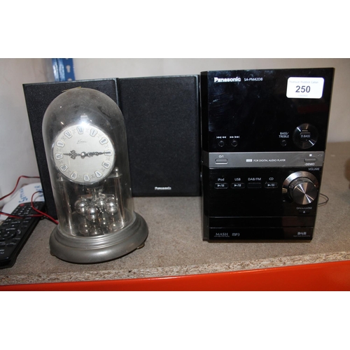 250 - Panasonic music player and speakers and a mantel clock under glass dome.