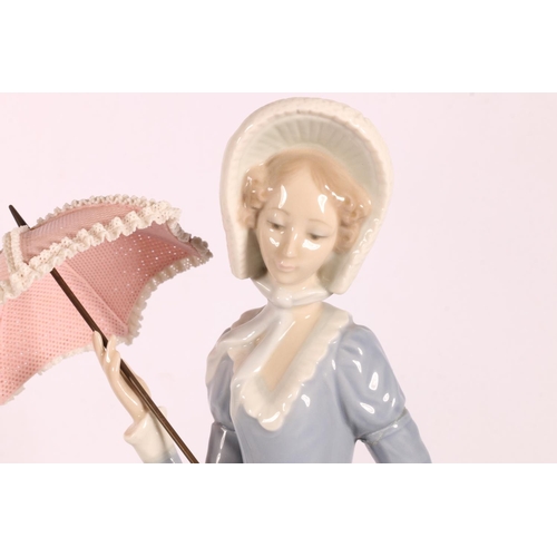 30 - Two Lladro ladies with parasols figurines to include Little Lady, #4879, and Lady with Umbrella, #48... 