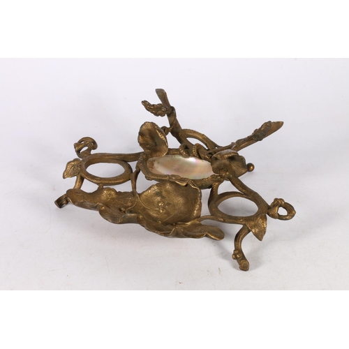 194 - 19th Century gilt metal and mother of pearl desk stand of naturalistic form, 24cm wide.