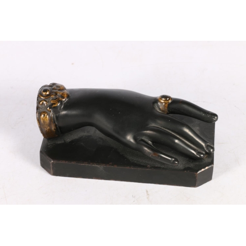 195 - Cast metal paperweight in the form of  a females hand, 13cm.