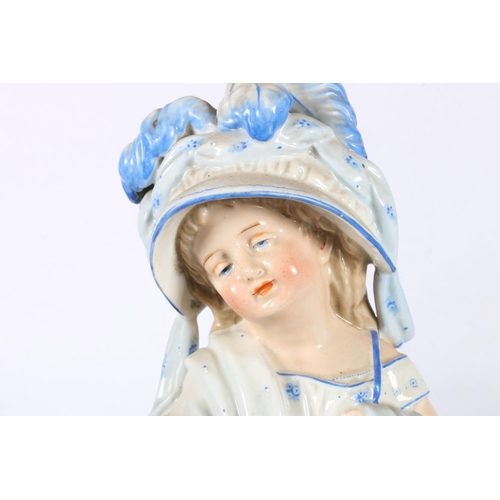 197 - Pair of continental porcelain piano babies, 25cm.