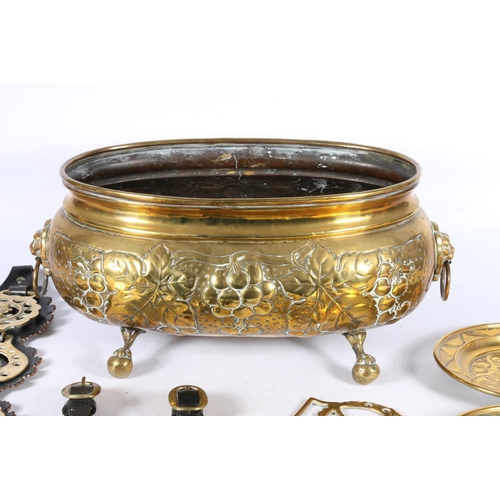 115 - Beaten brass planter of oval form, 16cm high, with horse brasses, etc.