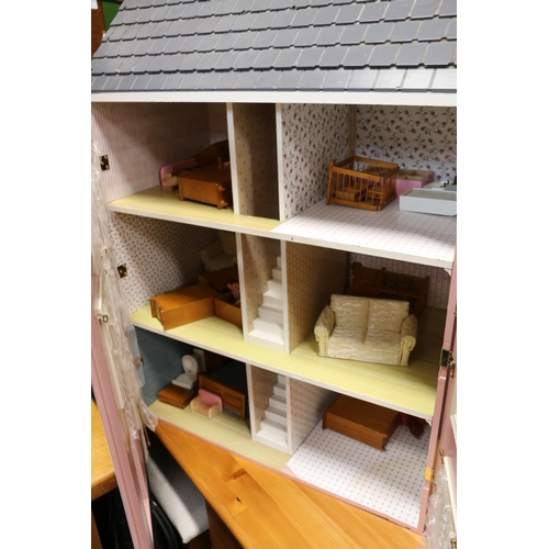 300A - Victorian style dolls house containing a quantity furniture, 81cm high.