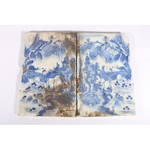 524 - Two 19th century oriental blue and white porcelain tiles, decorated as a mirror image of landscape s... 