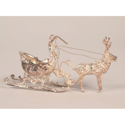 189 - Scandinavian 925  silver model of a reindeer pulling a sleigh with a putti aloft, 16cm.