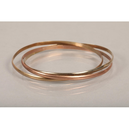 93 - 9ct tri-coloured gold three intertwined bangles, 14.7g.