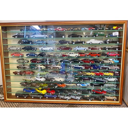 435 - Collection of die-cast cars, in a wall display cabinet.