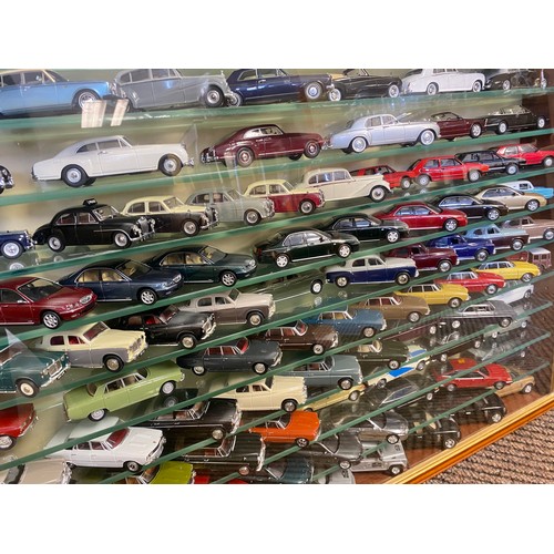 435 - Collection of die-cast cars, in a wall display cabinet.